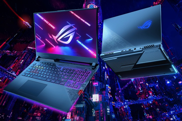 Neon city-inspired promotional image for Asus gaming laptops showcasing a laptop from the front and back against a colourful city background