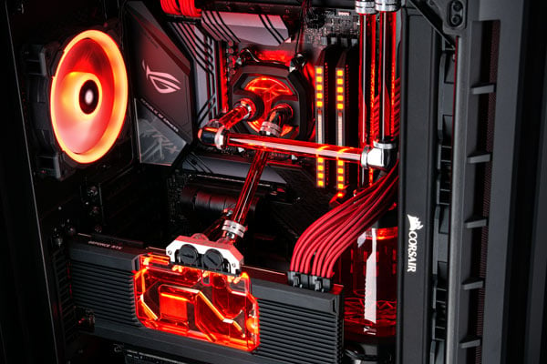 Image of the inside of a Chillblast Hydro X watercooled PC with red RGB lighting throughout