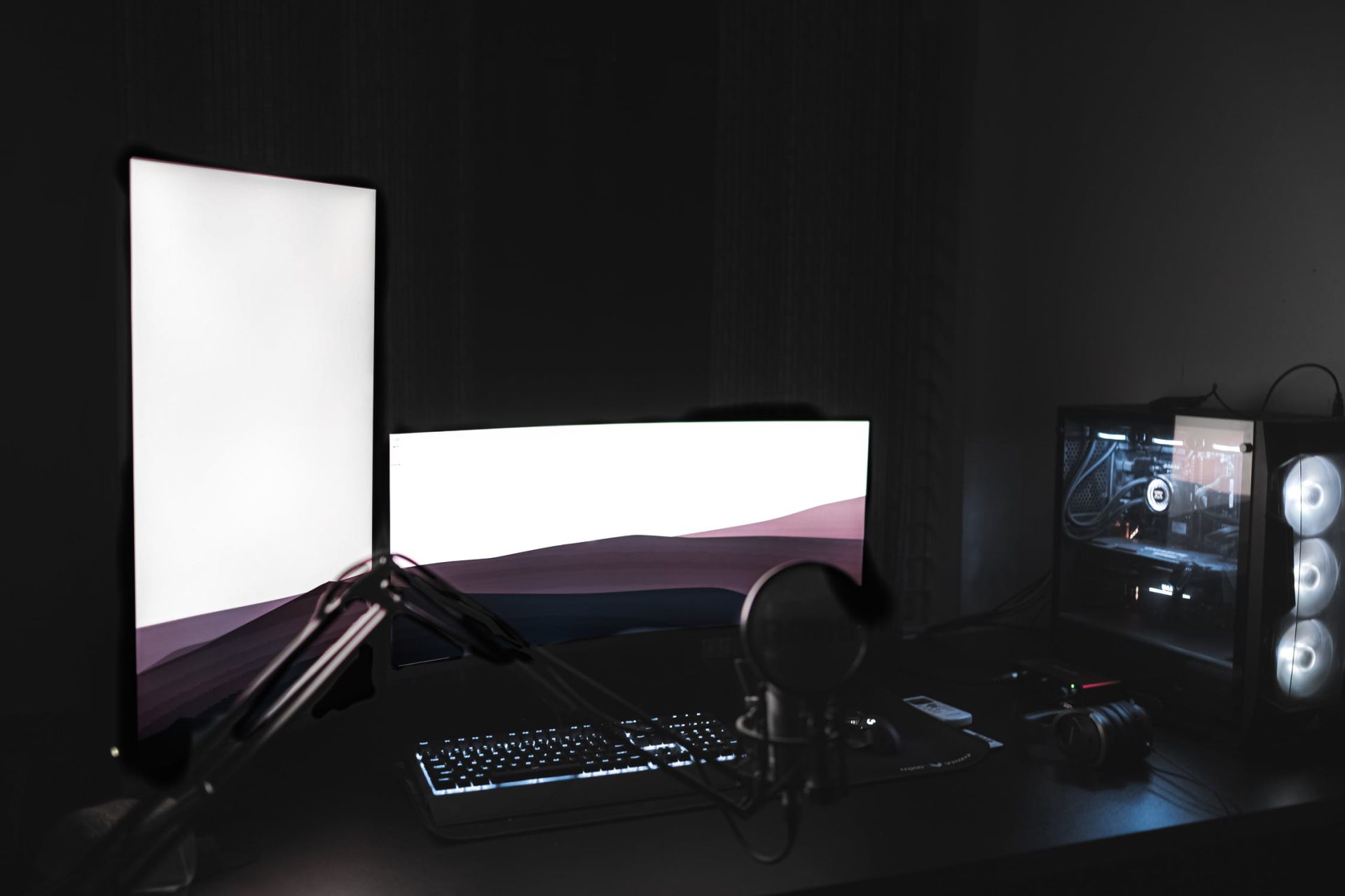 Dual PC Streaming Setup - Photo of a gaming PC with mic, headphones and dual monitor