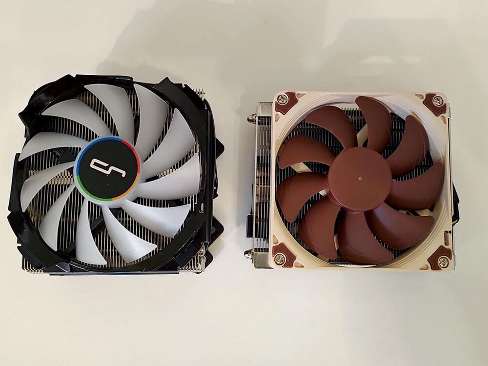 Photo of a Noctua NH-L9a-AM4 CPU cooler and a Cryorig C7 CPU cooler next to each other on a table