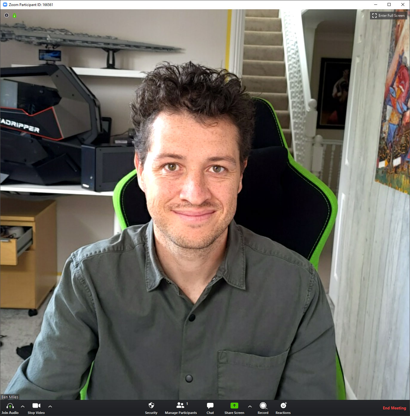 Screenshot of a Zoom call in which the image of the smiling man is being captured using his phone and DroidCam