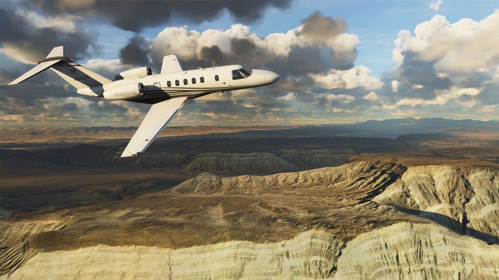 Screen capture image from FS2020 showing a jet engine plane flying over rocky terrain
