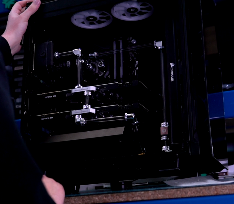 Image of a Chillblast PC builder inspecting the inside of a water-cooled PC