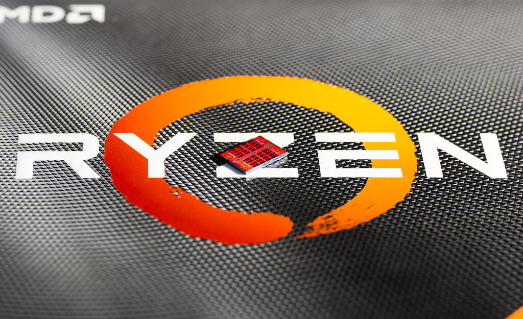 Close up of the Ryzen logo with a Ryzen CPU placed on top
