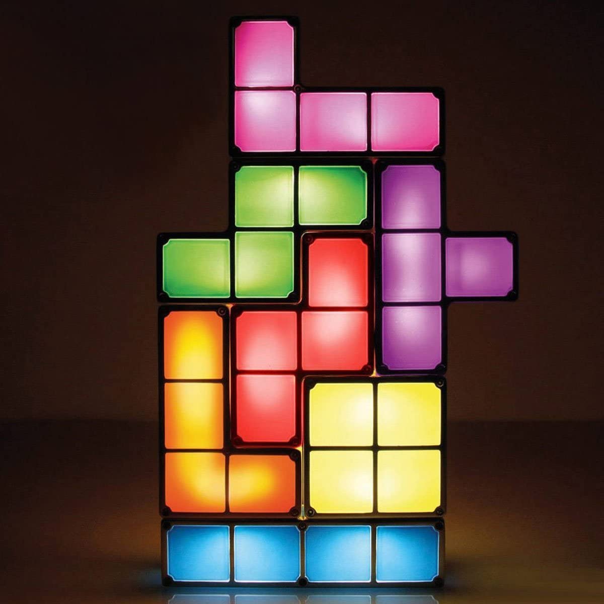 Image of a glowing Tetris lamp made of seven individual light up blocks