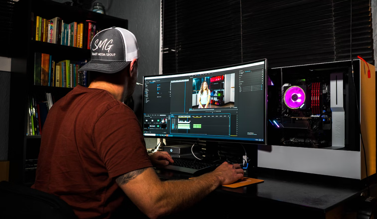 Man sat at a desk using a Video editor PC