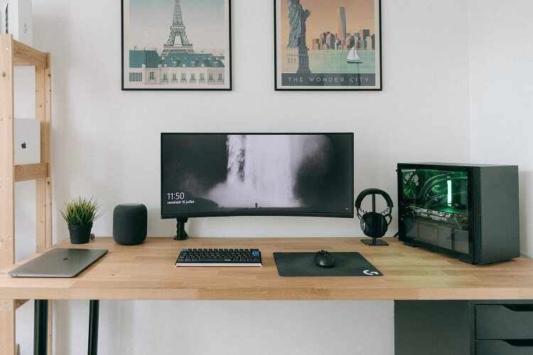 Photo of a minimalist desk setup with a single monitor and small PC with an Intel i3 CPU to the side