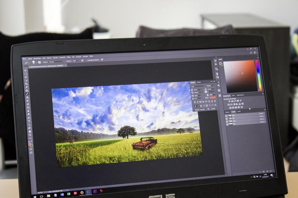 Image of an old car in a field being edited in photoshop