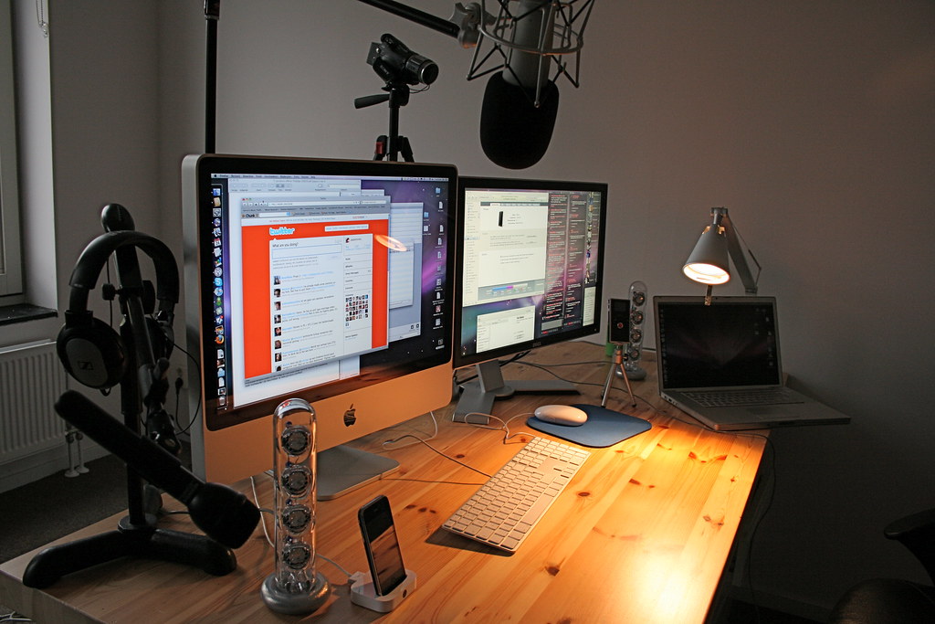 Image of a streaming desk setup including multiple monitors, a microphone and a camera