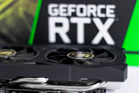 Image of an Nvidia RTX graphics card sat in front of its box